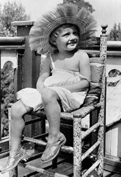 Audrey on chair on balcony