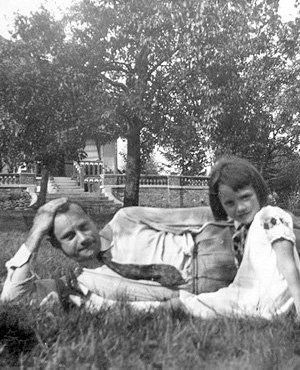 Audrey with her dad laying in garden